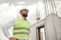 Confident contractor on construction site
